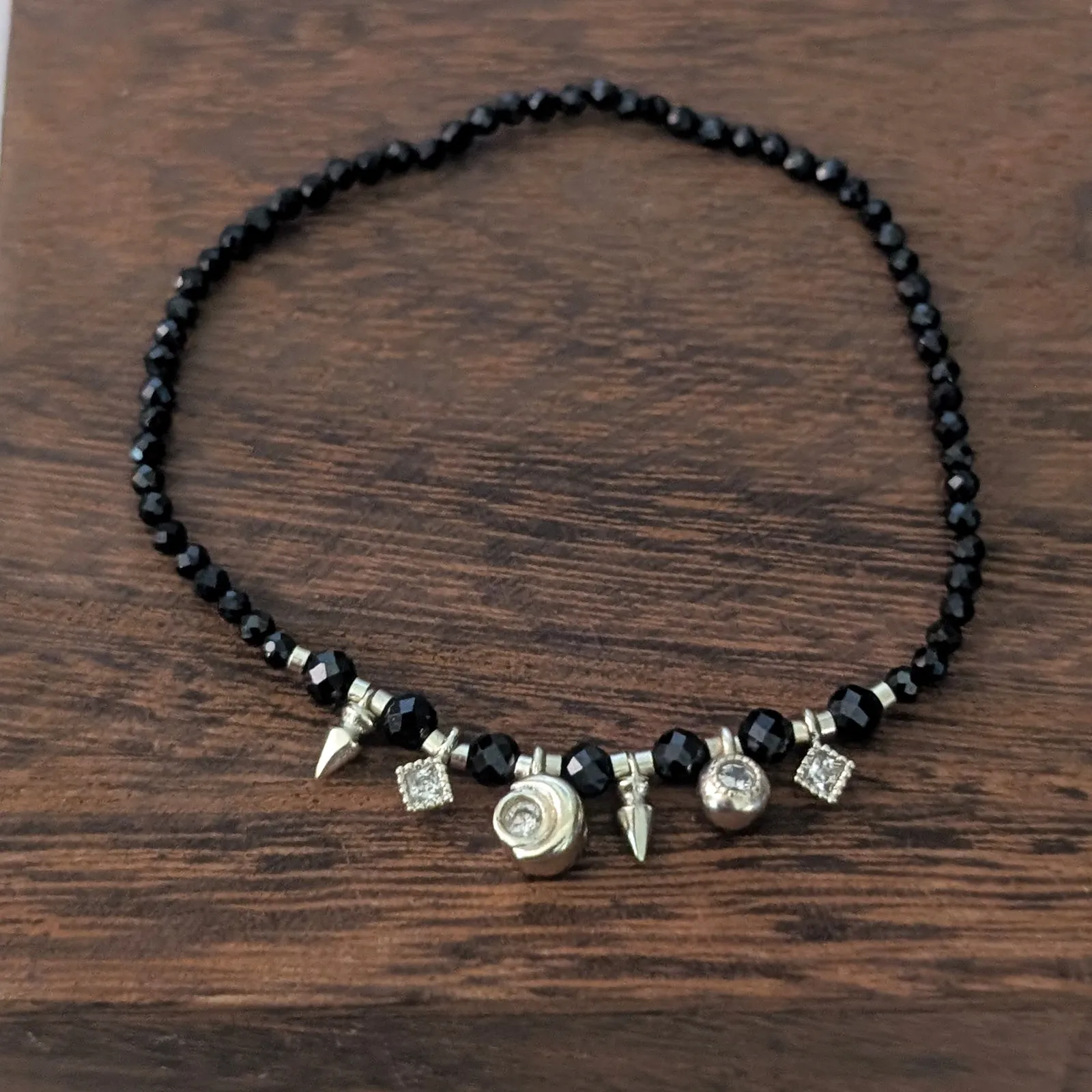 Thin Black Stretch Bracelet with Gold Tone Charms - Image 2