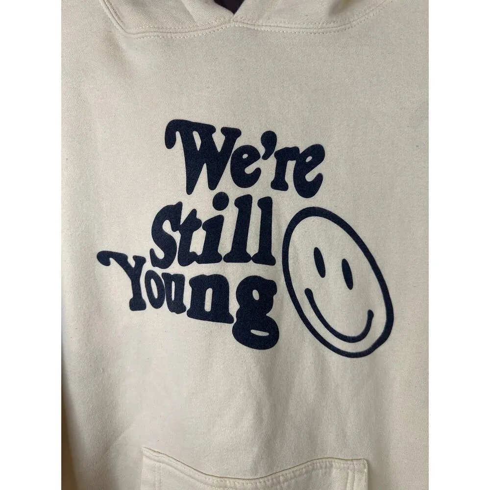 FanJoy Unisex ‘We’re Still Young’ Smiley Face Graphic Long Sleeve Hoodie Size M Yellow Size M - Image 2