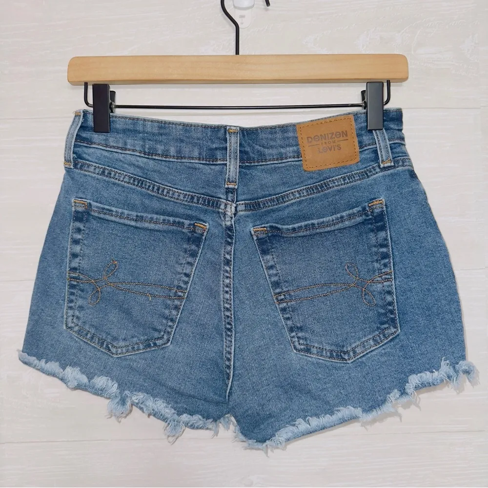Denizen from Levi's Women's Medium Wash Blue High Rise Cut Off Distressed Shorts - Image 6