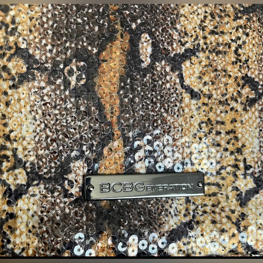 BCBGmaxazria White Glossy Sequined Styled Lazy Clutch in Animal Print Background - Image 9