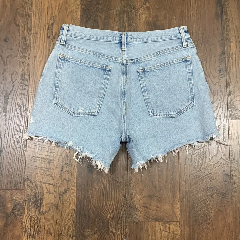 AGOLDE  Riley Short Light Wash Button Fly Distressed Cutoff Denim Shorts - Image 6