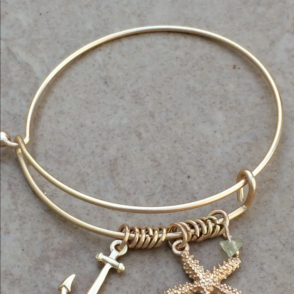 Gold Tone Starfish Anchor Quartz Charm Bangle - Image 2