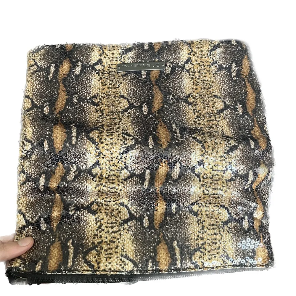 BCBGmaxazria White Glossy Sequined Styled Lazy Clutch in Animal Print Background - Image 3