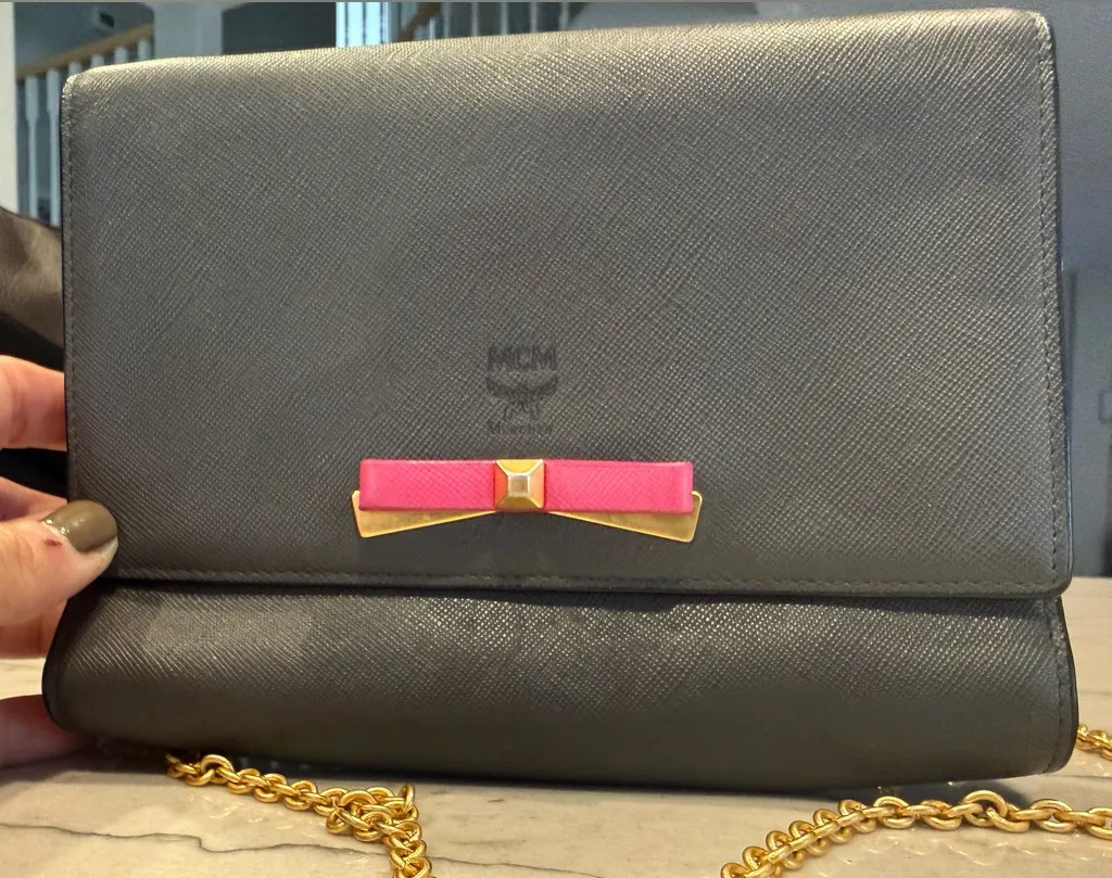 MCM Visetos Mina Crossbody Bag Dark Grey with a Pink Bow Accent - Image 1