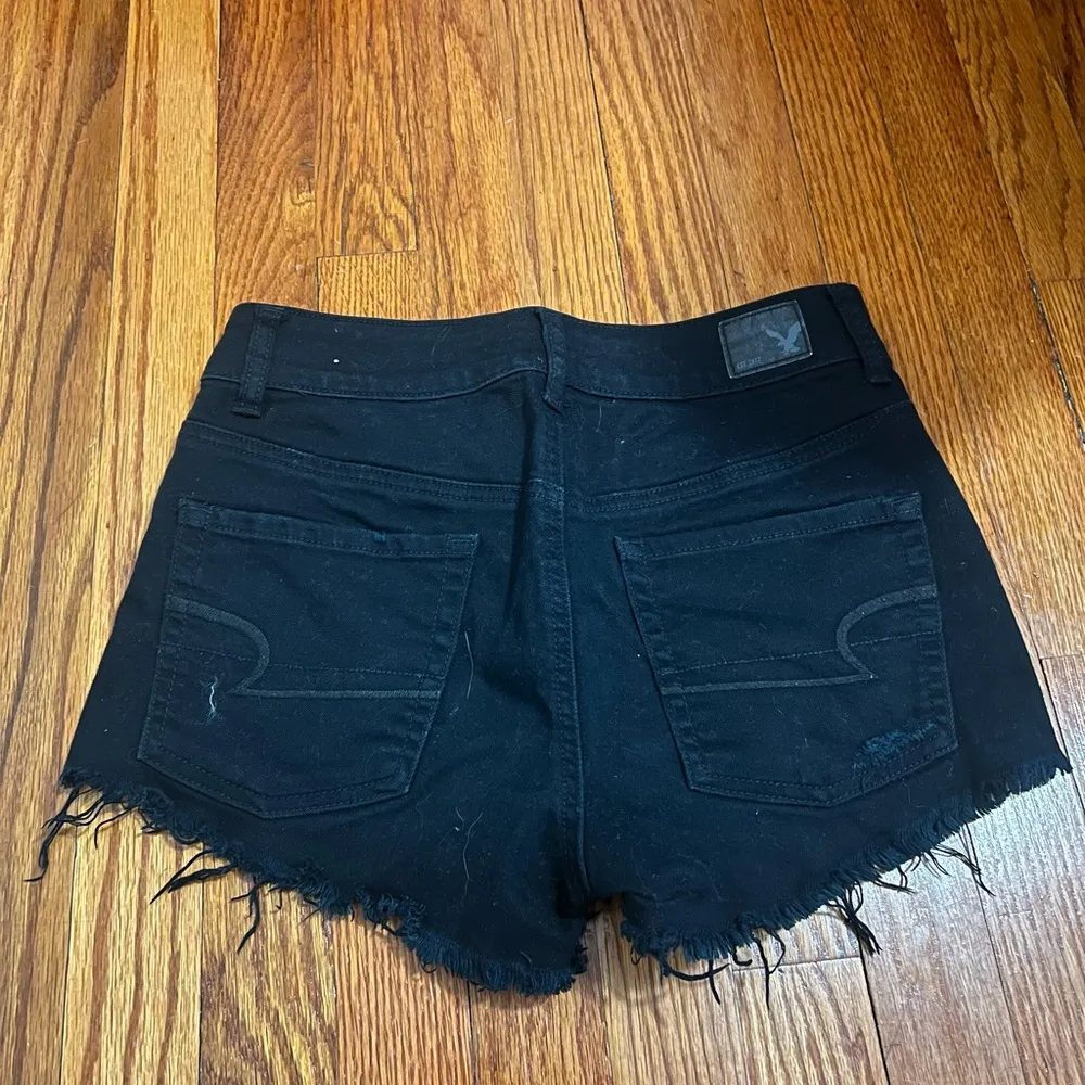 Size 4 black shorts with some rips. - Image 2