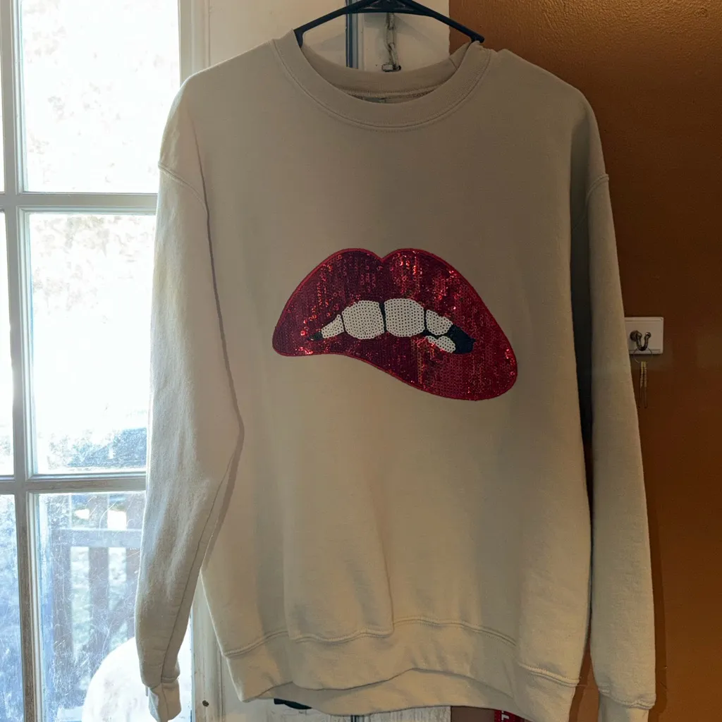 Stylish Cream Sweater with Red Lip Design size medium new - Image 3