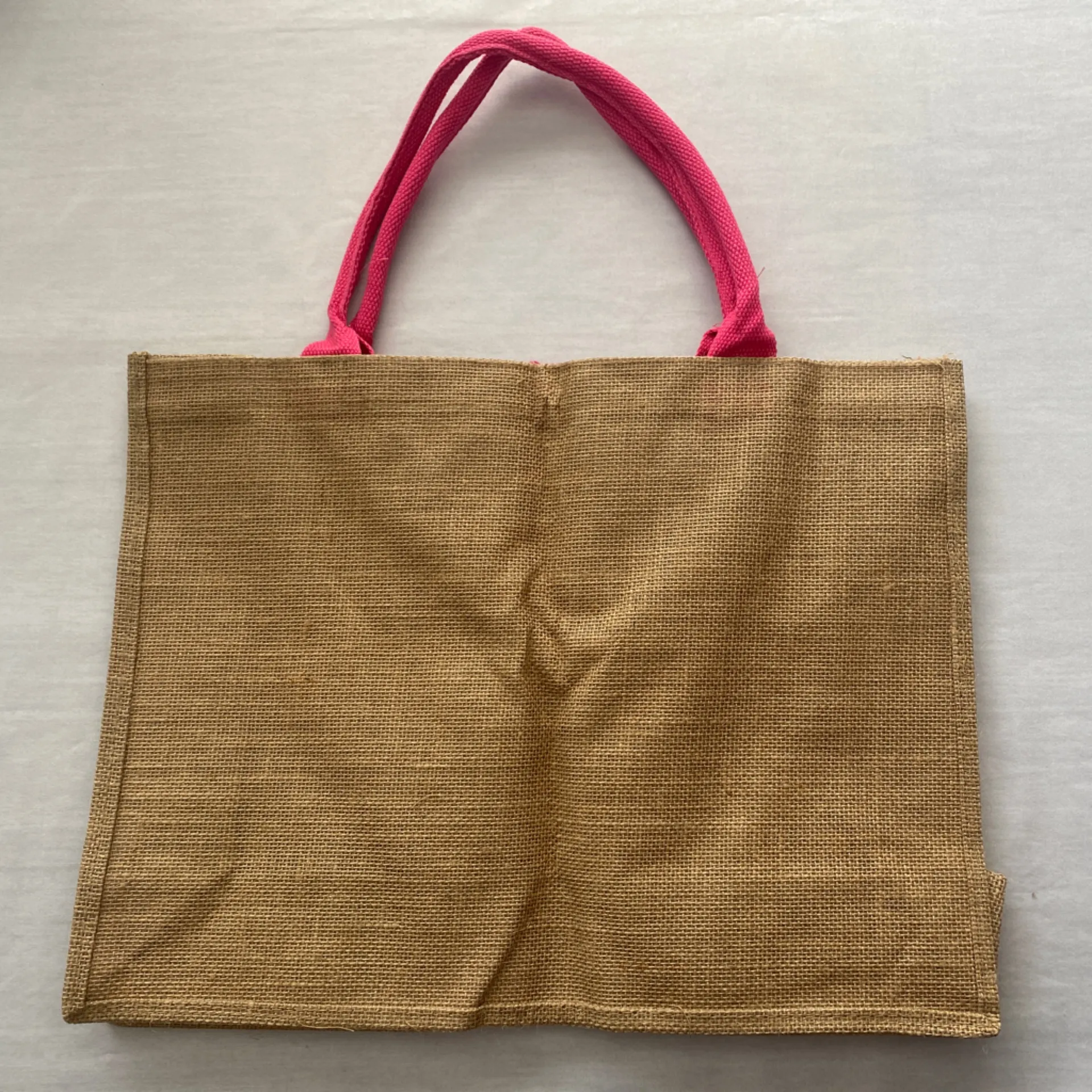 Jute Pink Tote‎ Bag Hello Weekend
Button loop closure
13.5” x 18” Tan - Image 2