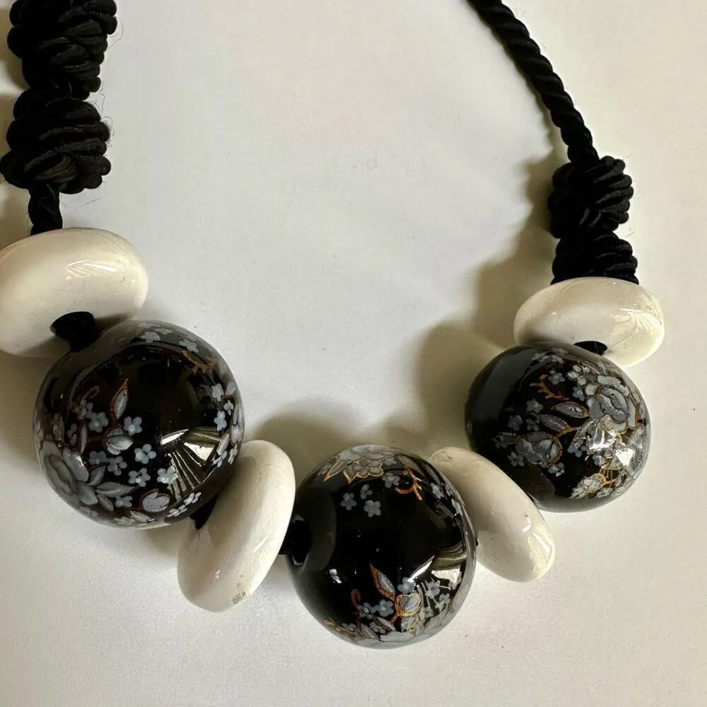 Black floral and white beaded necklace on black cord - Image 6