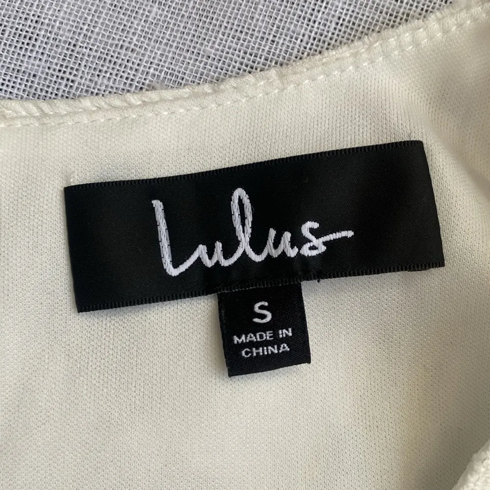 Lulu’s white cutout mini dress with sheer sleeves. - Image 4