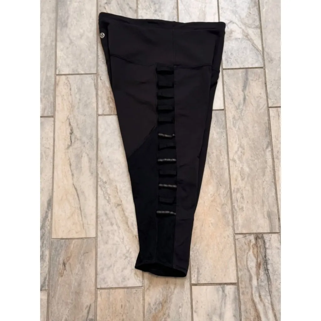 Lululemon women's size 6 black cropped leggings with reflective accents on sides - Image 6