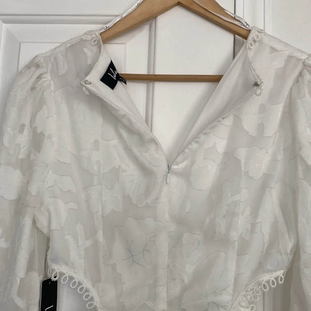 Lulu’s white cutout mini dress with sheer sleeves. - Image 11