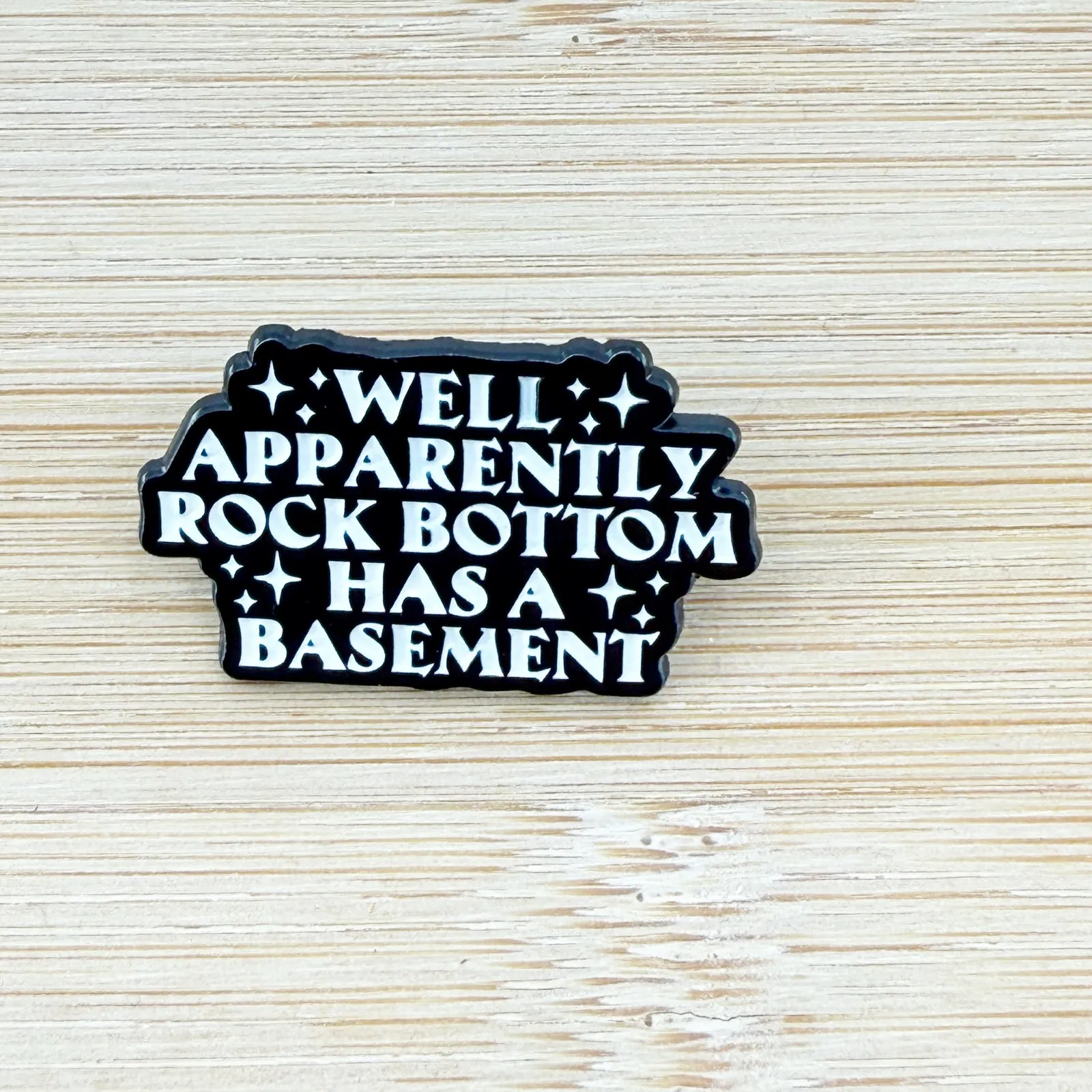 Well Apparently Rock Bottom Has A Basement Enamel Pin Black - Image 2