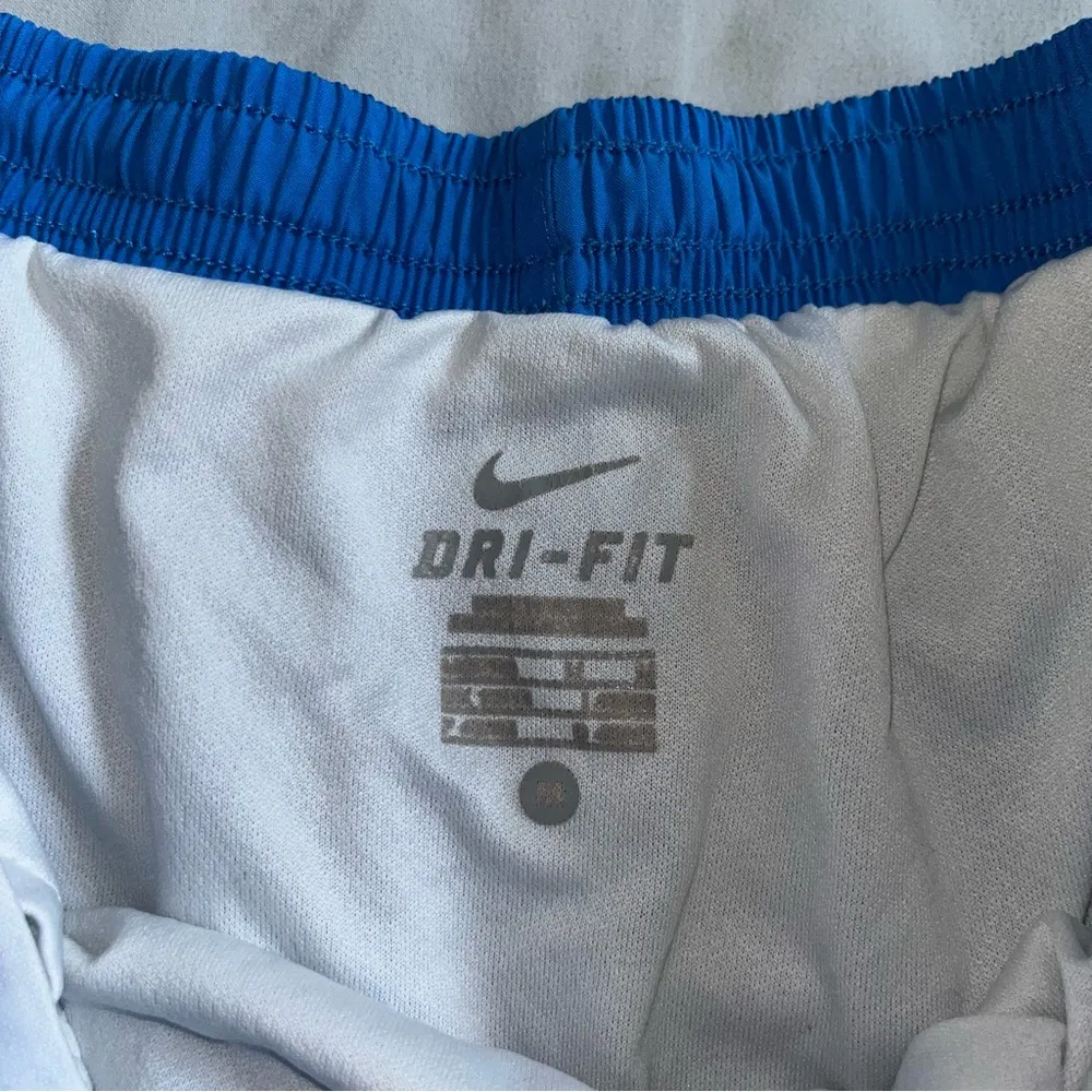 Nike Dri-Fit blue elastic waist lined shorts with green trim, adult size Medium - Image 3