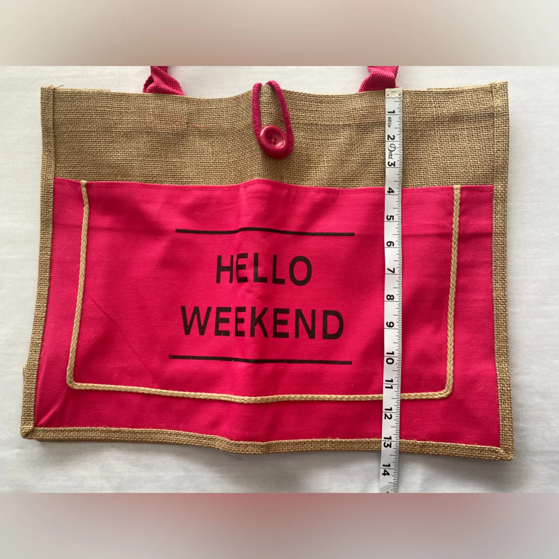 Jute Pink Tote‎ Bag Hello Weekend
Button loop closure
13.5” x 18” Tan - Image 4