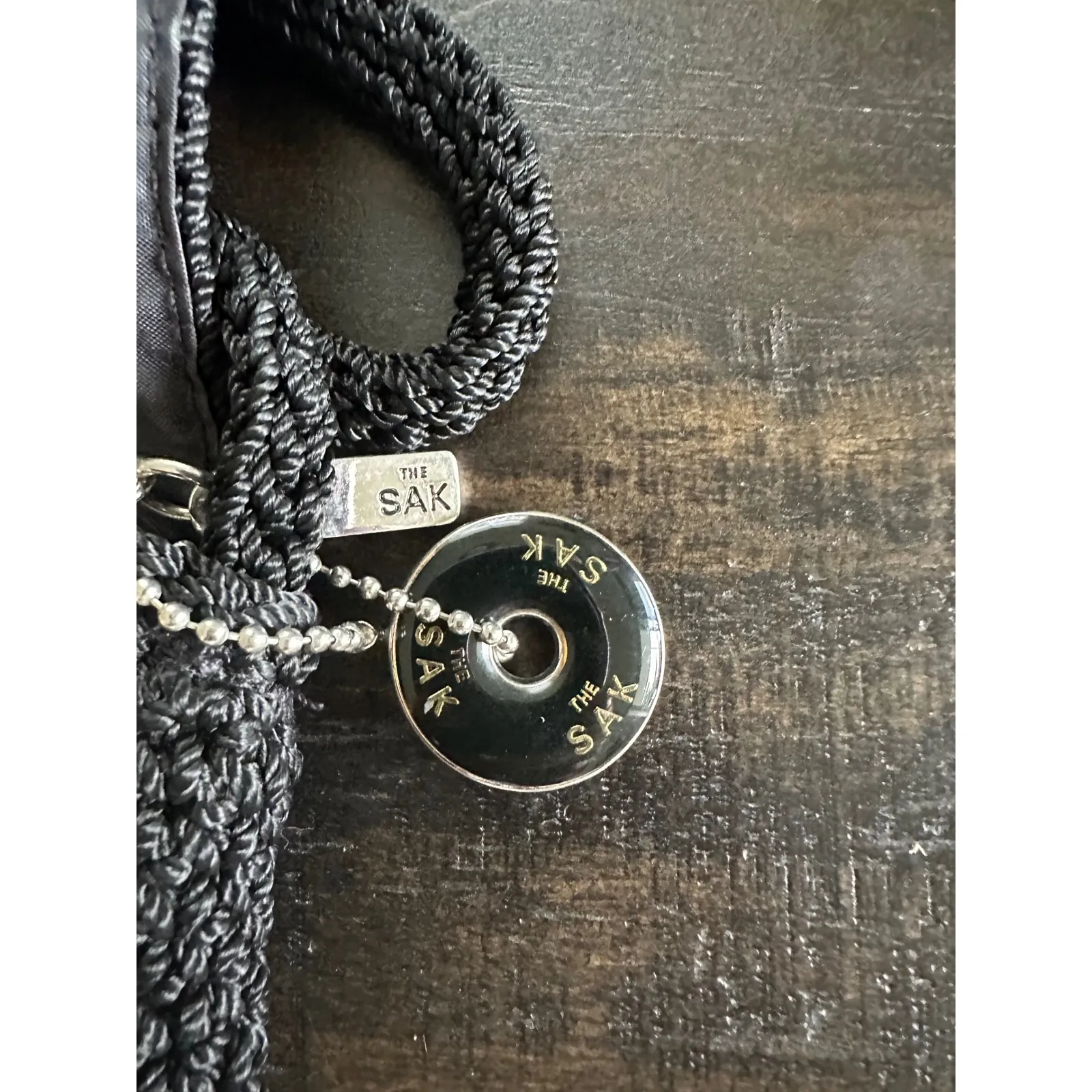 The Sak Black Crochet Crossbody Bag Woven Strap Flap Closure Charm Like new cond - Image 3