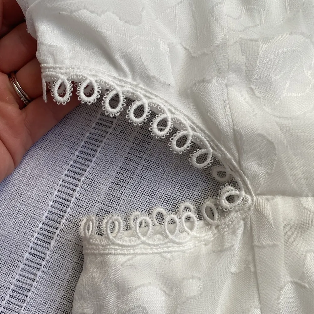 Lulu’s white cutout mini dress with sheer sleeves. - Image 6