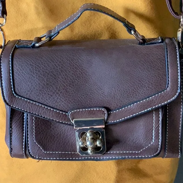 Go with every thing purse in brown with unique front latch and removable strap. - Image 2
