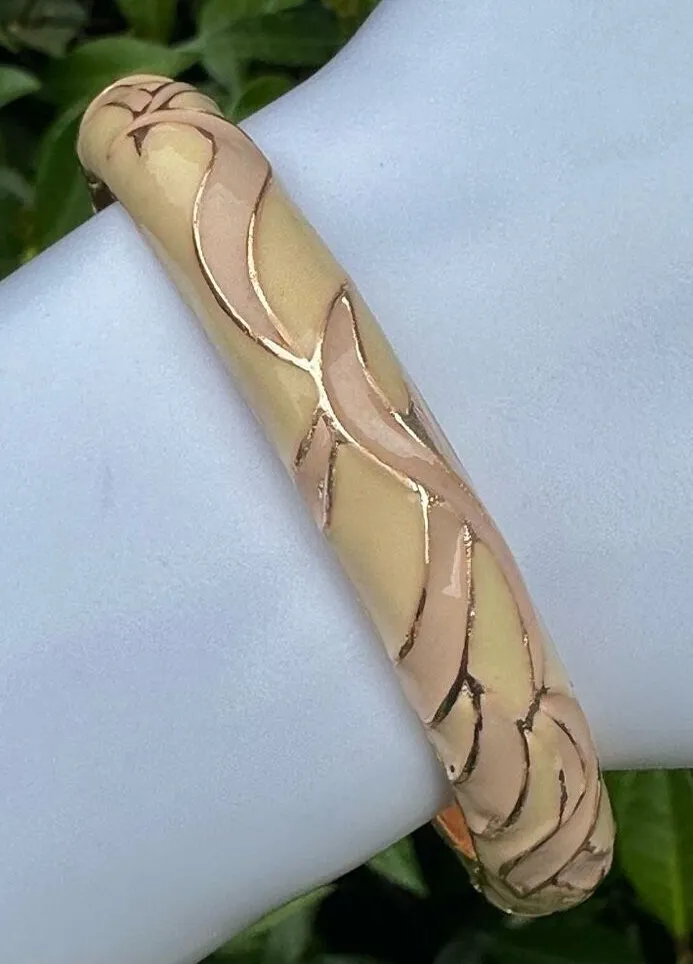 Cream enamel and gold tone hinged bangle bracelet