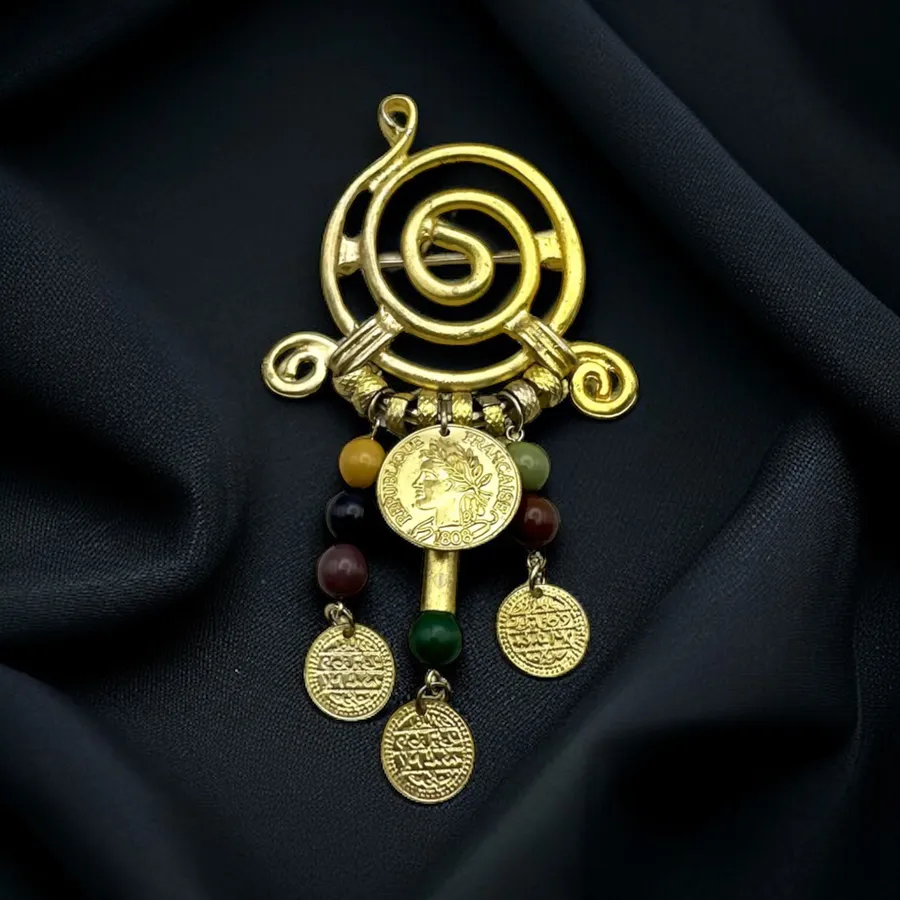 Vintage gold tone swirly brooch with dangling beads and coins