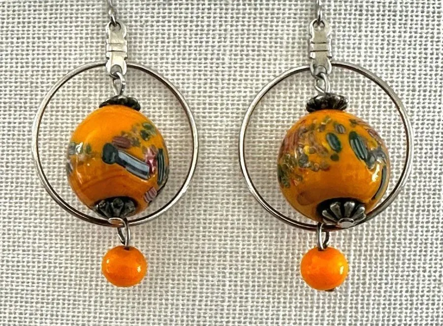 Silver tone orange beaded drop earrings