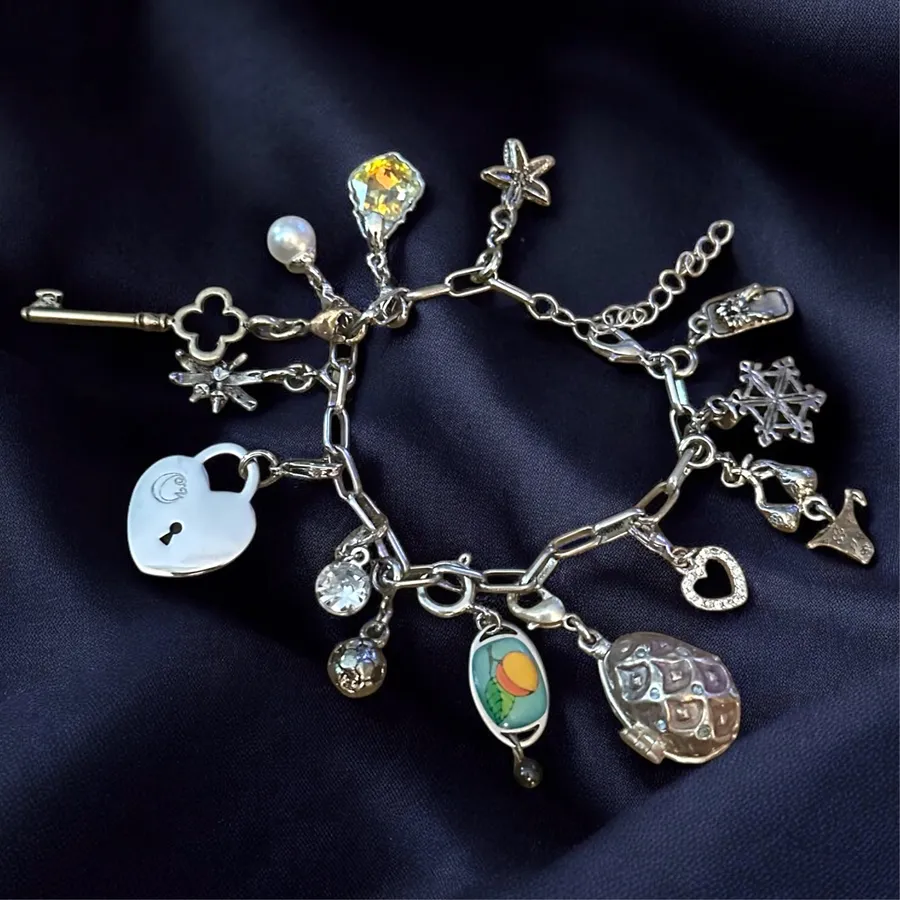 Silver tone loaded charm bracelet