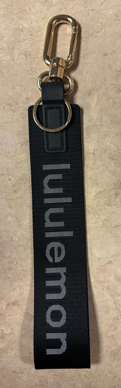 NWOT lululemon Never Lost Keychain Wordmark Black Gold Bag Charm SOLD OUT