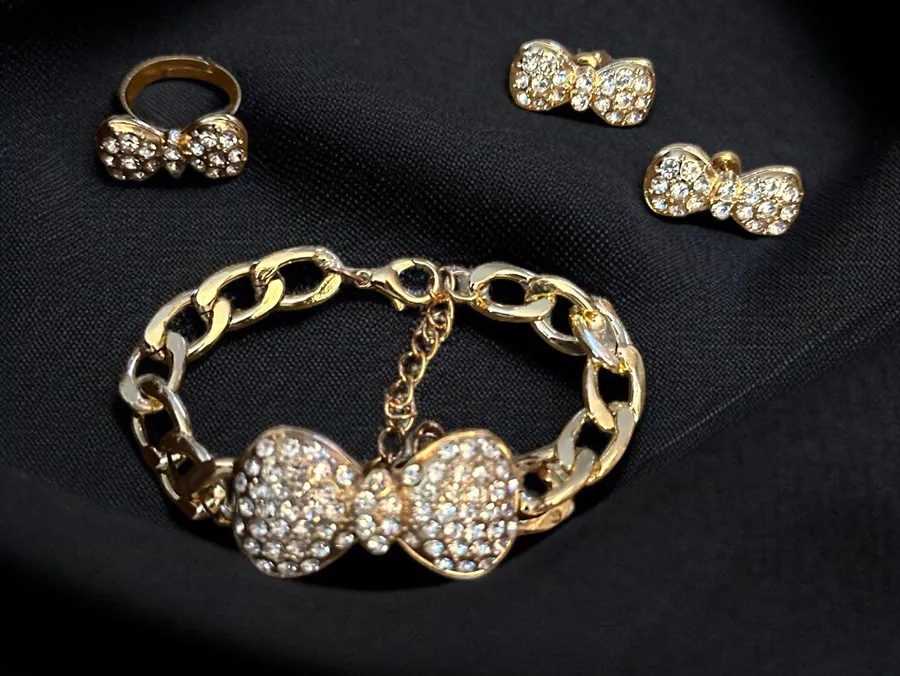 Gold tone pave bow tie bracelet, earrings and ring set