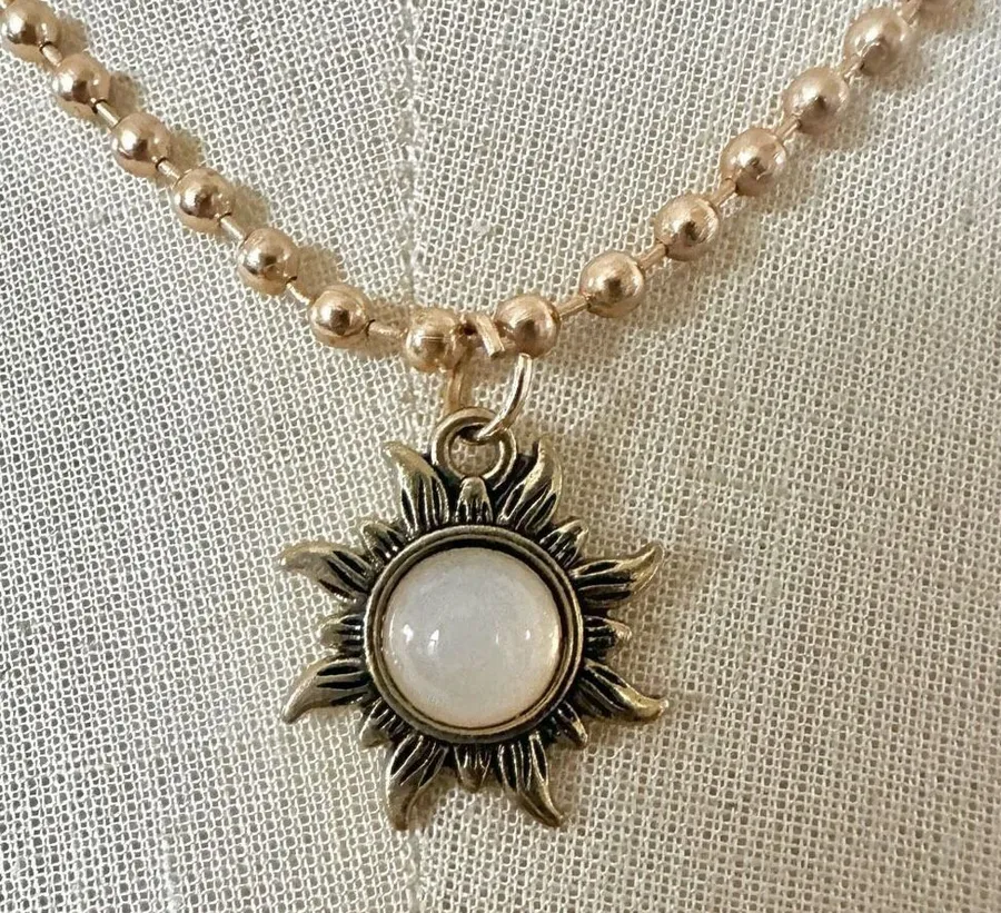 Gold tone sun pendant necklace