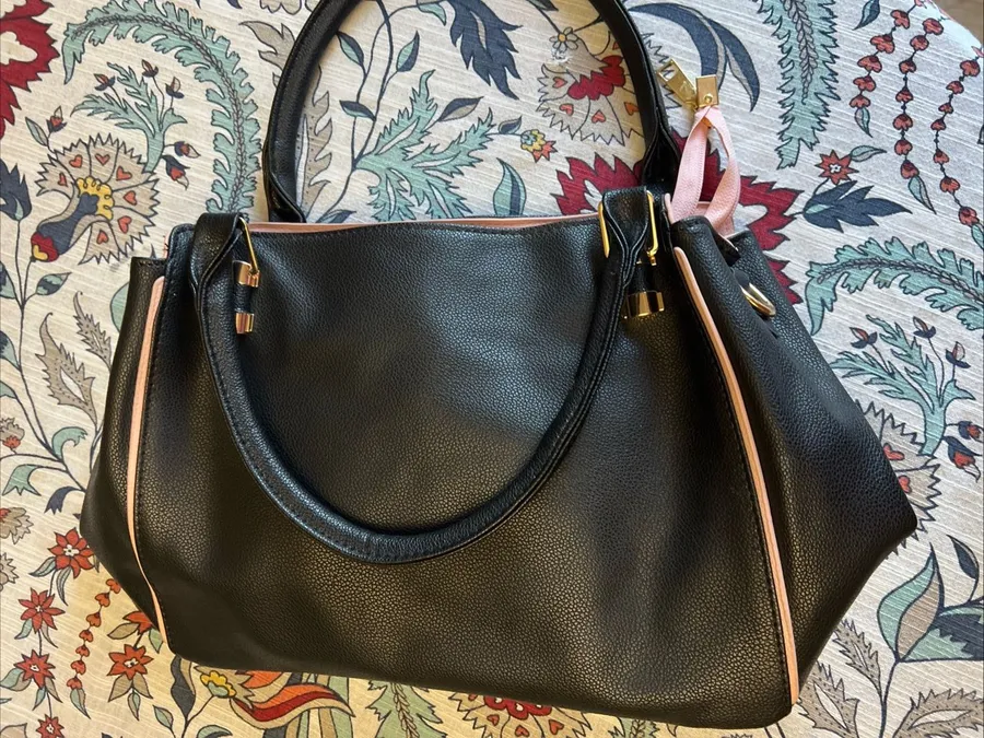 Sleek Black Pebbled Tote with Pink Trim and Gold Hardware