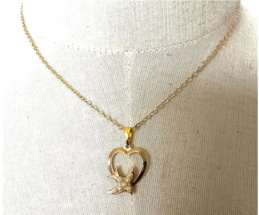 Gold tone heart with faux pearl bird pendant necklace