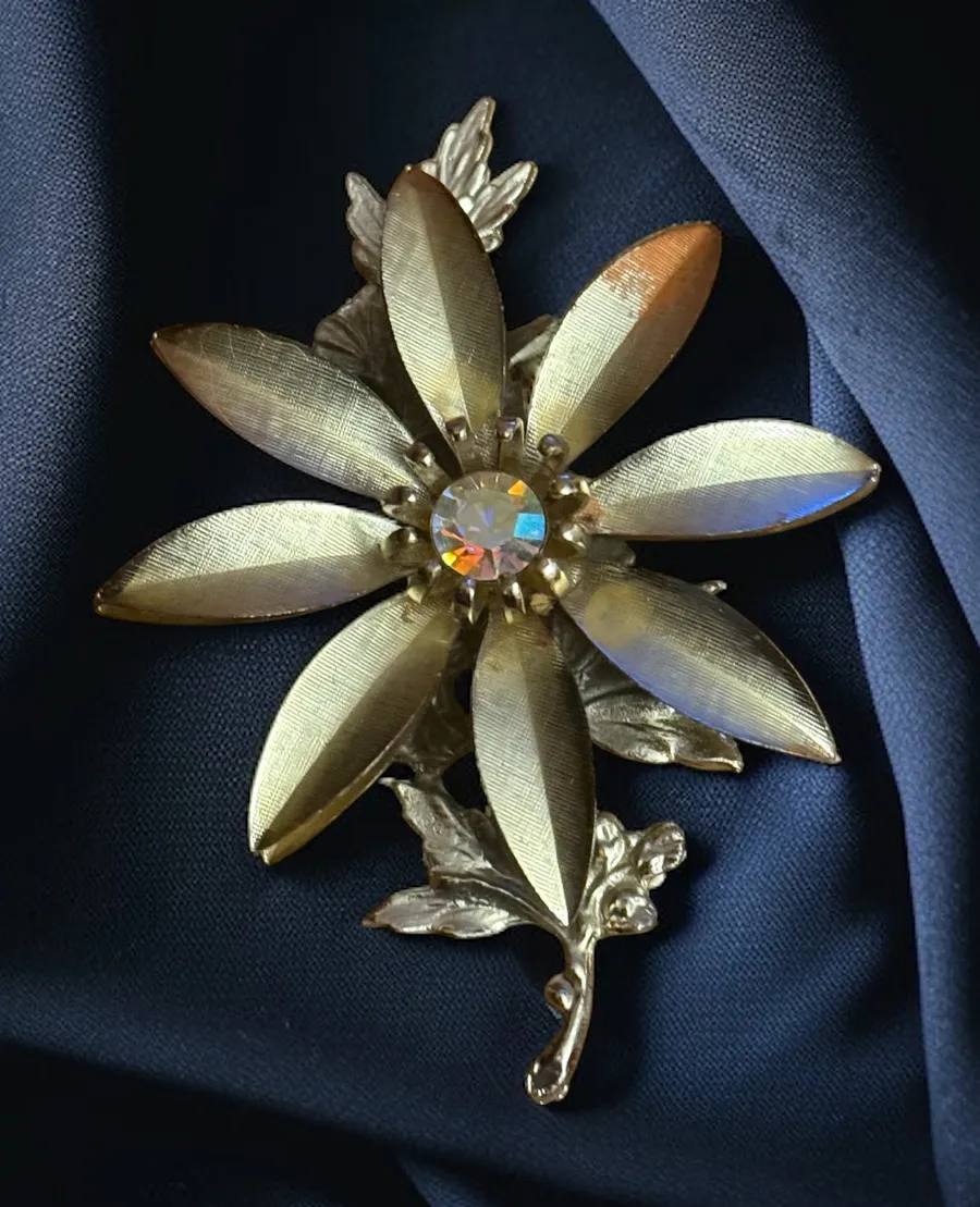Vintage gold tone aurora borealis crystal center flower brooch