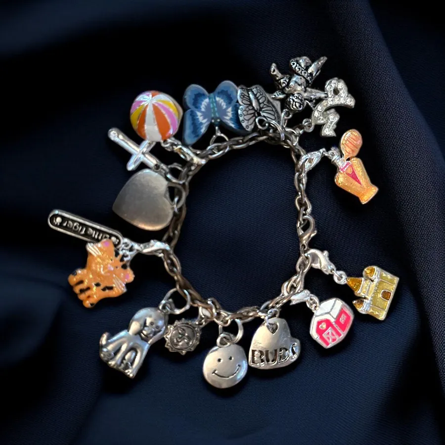 Silver tone loaded charm bracelet