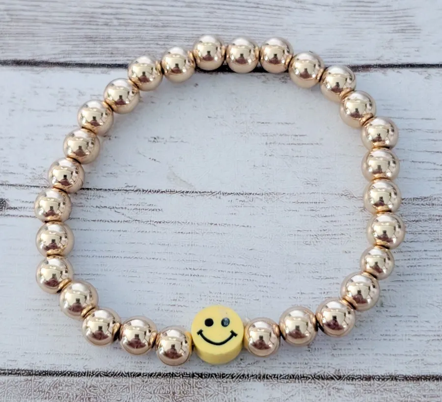 Gold Tone Stretch Bracelet with Yellow Smiley Face