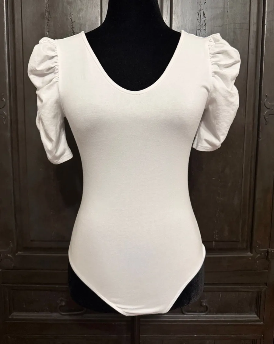 Vylette White bodysuit with Puffy Sleeves - Size Medium. ***refer to measurements. Super Cute top gentle worn and in excellent condition. Cotton/ spandex material. Measurements approximately for the bodysuit/ 14” from armpit to armpit x 25” from shoulder to snaps in crotch. Non-smoking home. Priced to sell at as is condition. Don’t like my price please make reasonable offer.