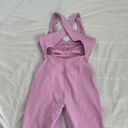 Free People Movement Here On Out Strappy Onesie Romper   Size XS  Condition: NWT  Color: bright orchid   Details : - See photo for approx. inseam measurement laying flat  - Built-in bra - not padded - Side pockets. Photo 4