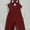 Free People Movement Here On Out Strappy Onesie Romper   Size XS  Condition: NWT  Color: nutmeg  Details : - See photo for approx. inseam measurement laying flat  - Built-in bra - not padded - Side pockets. Photo 0