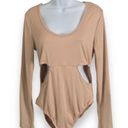 One Piece Love Streak Bodysuit Size L NWT  Elevate your wardrobe with this gorgeous Love Streak Bodysuit. Perfect for any occasion, this  features a flattering beige color and comfortable regular fit. The bodysuit is designed with a beautiful Love Streak brand that adds a touch of style and elegance. It's made with high-quality materials that guarantee durability and comfort.  This size L bodysuit is new with tags and is sure to make you feel confident and stylish. Whether you're dressing up for a night out or keeping it casual, this Love Streak Bodysuit is a must-have addition to your wardrobe. Photo 2