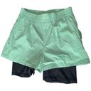 We Wore What  layered green black spandex running shorts Photo 2