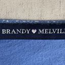 Brandy Melville Beautiful blue with tiny white flowers wrap top, long sleeves, has stretch, excellent condition, size medium Measurements: Bust: armpit to armpit 16 inches  Length: shoulder seam to bottom 17 inches Photo 4