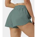 Halara  High Waisted Dolphin Hem Shorts Green Size L NWT Photo 1