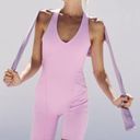 Free People Movement Here On Out Strappy Onesie Romper   Size XS  Condition: NWT  Color: bright orchid   Details : - See photo for approx. inseam measurement laying flat  - Built-in bra - not padded - Side pockets. Photo 6