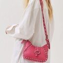 Urban Outfitters hot pink studded shoulder bag. Photo 0