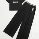 Mulvari Letter Graphic Off Shoulder Tee & Contrast Tape Wide Leg Pants Black Size M Photo 0