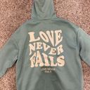 Love Never Fails Hoodie Size L Photo 0