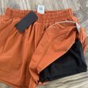 Alphalete Woman’s Infinity Stride Short W/ Liner - Sour Tangerine, Size Medium Photo 8