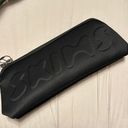 SKIMS NWT Neoprene long zip pouch Photo 0