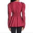 Rebellion Aje  Tucked Peplum V-Neck Long Sleeve Corset Top in Magenta Photo 1