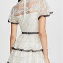 Shoshanna Stacia Lace Tiered Polka Dot Knee Length High Neck Black trim on neck/sleeve/bottom Hidden back zipper A flutter sleeve ballet lace fit-and-flare mini dress with ruffle detail below the waist ivory cream Kentucky Derby mock sheer layer Photo 1