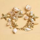 Jewelry by Lyra Beachy gold and white charm bracelet with starfish and seashells. NWT Photo 1