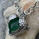 Green gemstone in a winged heart shaped necklace cage. 36”chain. Heart opens Photo 1